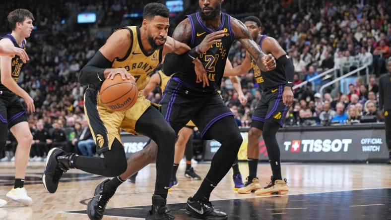 Apr 2, 2024; Toronto, Ontario, CAN; Toronto Raptors forward Garrett Temple (17) controls the ball as Los Angeles Lakers forward LeBron James (23) tries to defend during the third quarter at Scotiabank Arena. Mandatory Credit: Nick Turchiaro-USA TODAY Sports