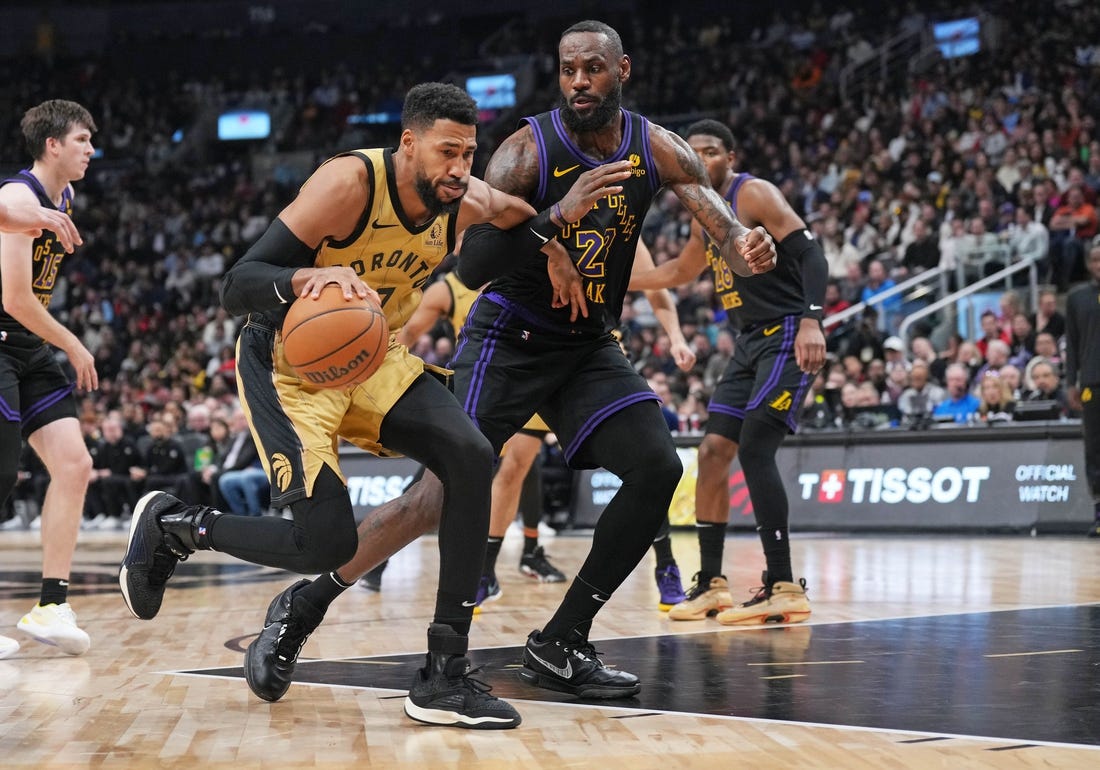 Apr 2, 2024; Toronto, Ontario, CAN; Toronto Raptors forward Garrett Temple (17) controls the ball as Los Angeles Lakers forward LeBron James (23) tries to defend during the third quarter at Scotiabank Arena. Mandatory Credit: Nick Turchiaro-USA TODAY Sports
