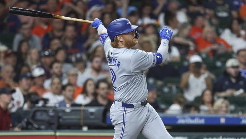 Apr 2, 2024; Houston, Texas, USA; Toronto Blue Jays designated hitter Justin Turner (2) hits a single during the seventh inning against the Houston Astros at Minute Maid Park. Mandatory Credit: Troy Taormina-USA TODAY Sports