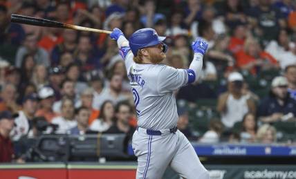 Apr 2, 2024; Houston, Texas, USA; Toronto Blue Jays designated hitter Justin Turner (2) hits a single during the seventh inning against the Houston Astros at Minute Maid Park. Mandatory Credit: Troy Taormina-USA TODAY Sports