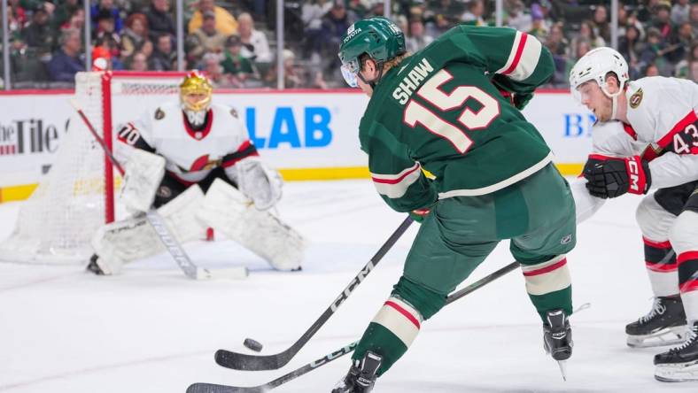 Apr 2, 2024; Saint Paul, Minnesota, USA; Minnesota Wild center Mason Shaw (15) shoots against the Ottawa Senators goaltender Joonas Korpisalo (70) in the second period at Xcel Energy Center. Mandatory Credit: Brad Rempel-USA TODAY Sports