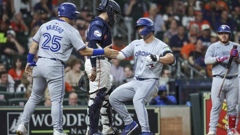 Apr 2, 2024; Houston, Texas, USA; Toronto Blue Jays left fielder Davis Schneider (36) celebrates with left fielder Daulton Varsho (25) after hitting a home run during the ninth inning against the Houston Astros at Minute Maid Park. Mandatory Credit: Troy Taormina-USA TODAY Sports