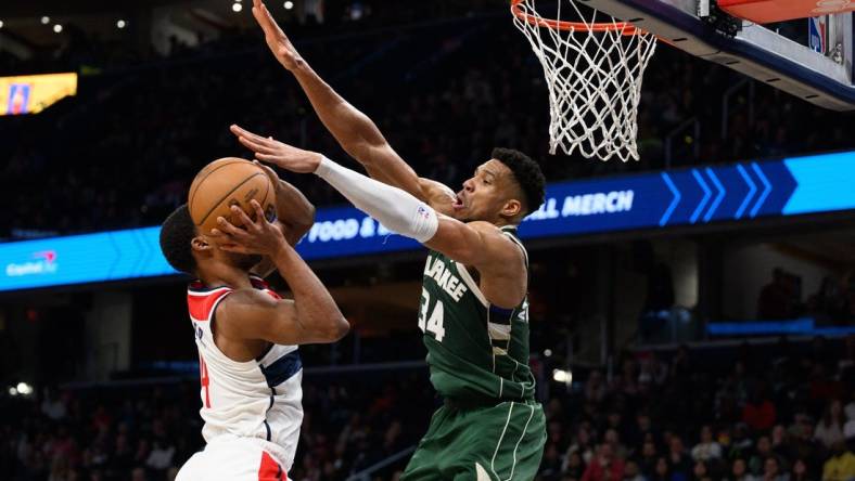 Apr 2, 2024; Washington, District of Columbia, USA; Milwaukee Bucks forward Giannis Antetokounmpo (34) defends against Washington Wizards guard Jared Butler (4) during the fourth quarter at Capital One Arena. Mandatory Credit: Reggie Hildred-USA TODAY Sports