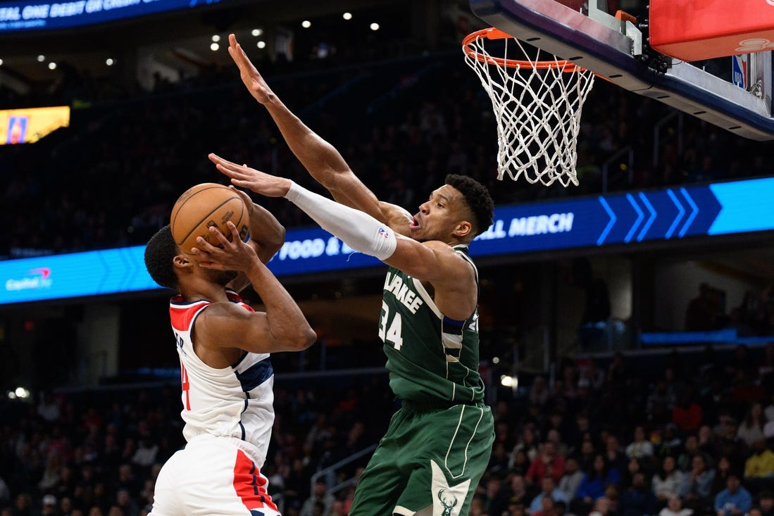 Apr 2, 2024; Washington, District of Columbia, USA; Milwaukee Bucks forward Giannis Antetokounmpo (34) defends against Washington Wizards guard Jared Butler (4) during the fourth quarter at Capital One Arena. Mandatory Credit: Reggie Hildred-USA TODAY Sports