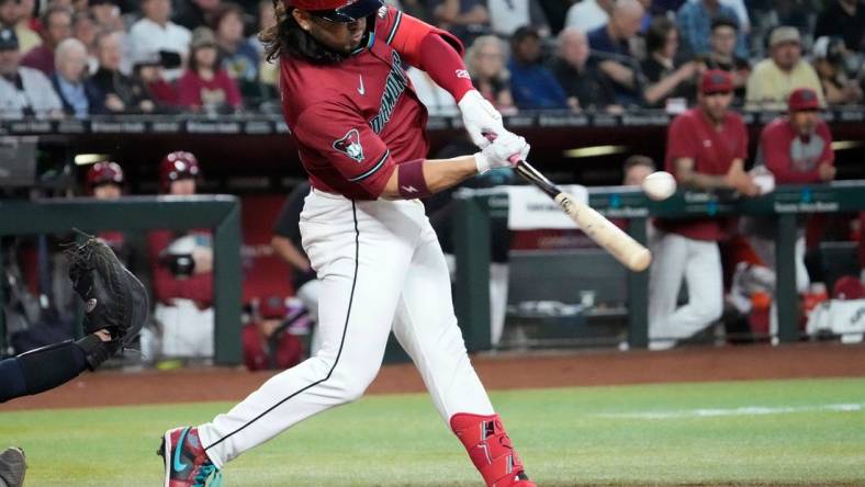 Arizona Diamondbacks third baseman Eugenio Suarez (28) hits a single against the New York Yankees during the first inning at Chase Field in Phoenix on April 2, 2024.