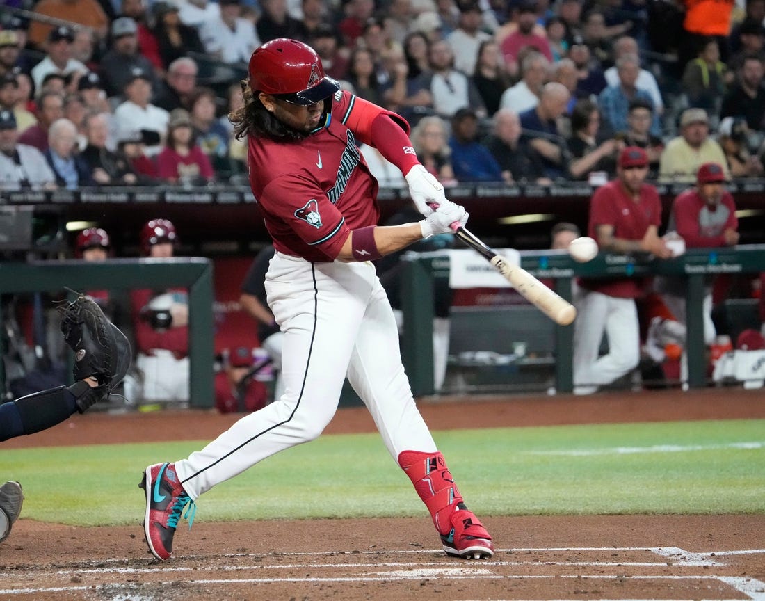 Arizona Diamondbacks third baseman Eugenio Suarez (28) hits a single against the New York Yankees during the first inning at Chase Field in Phoenix on April 2, 2024.