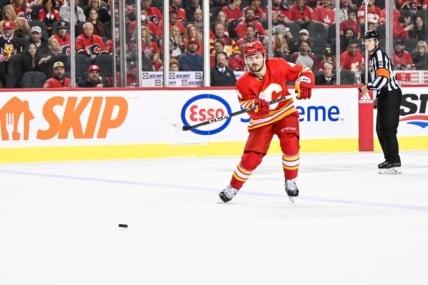 CALGARY, AB - OCTOBER 18: Calgary Flames Defenceman Rasmus Andersson (4) passes the puck during the second period of an NHL game between the Calgary Flames and the Vegas Golden Knights on October 18, 2022, at the Scotiabank Saddledome in Calgary, AB. (Photo by Brett Holmes/Icon Sportswire)
