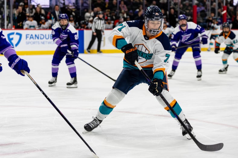 New York Sirens defender Jincy Roese digs out the puck in the corner against the Minnesota Frost.